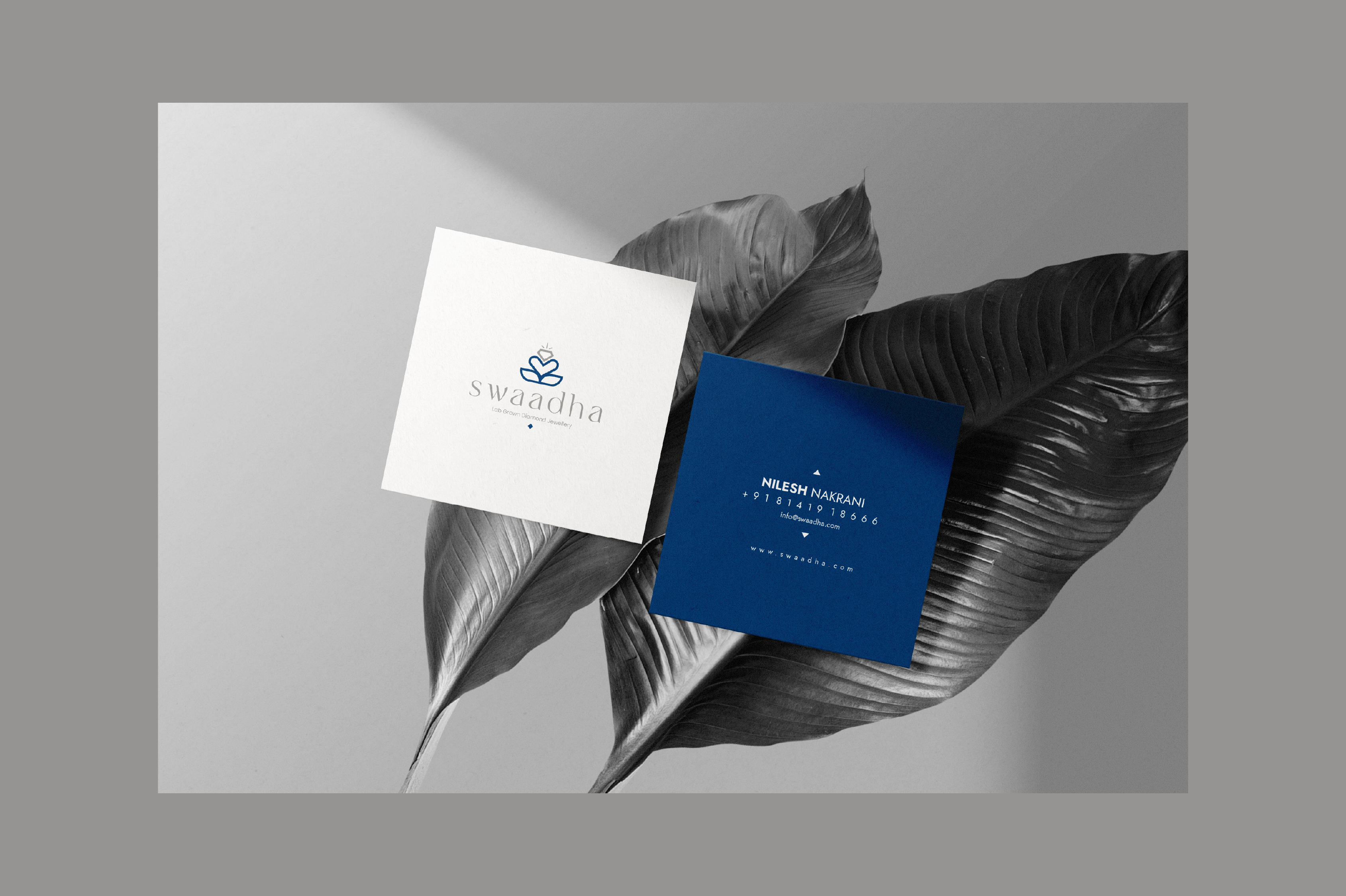 Swaadha square business cards in white and navy on monochrome tropical leaves
